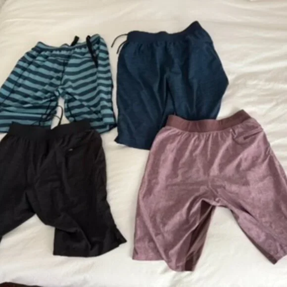 FOUR PAIRS OF VINTAGE LIMITED EDITION LULULEMON PACEBREAKER 9" ATHLETIC SHORTS
